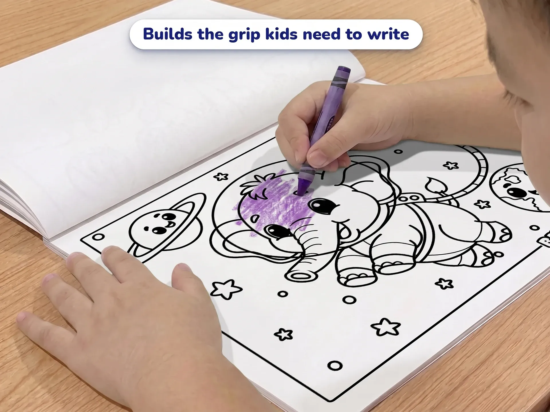 A young child coloring a picture of an elephant astronaut in space