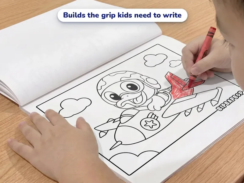 Child with a blue crayon coloring a picture of a duck flying a jet airplane