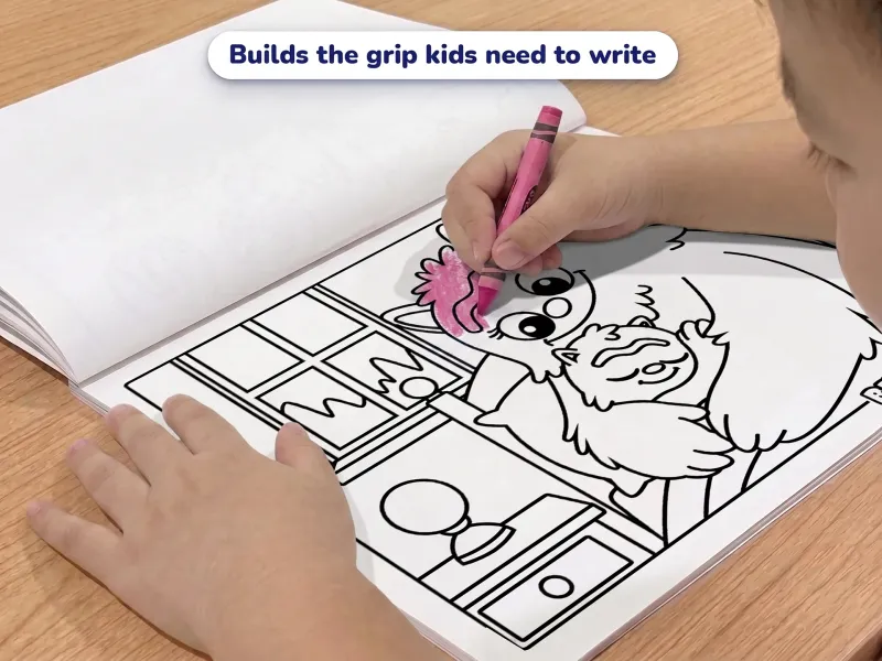 Child with a crayon coloring a picture of a monster in bed