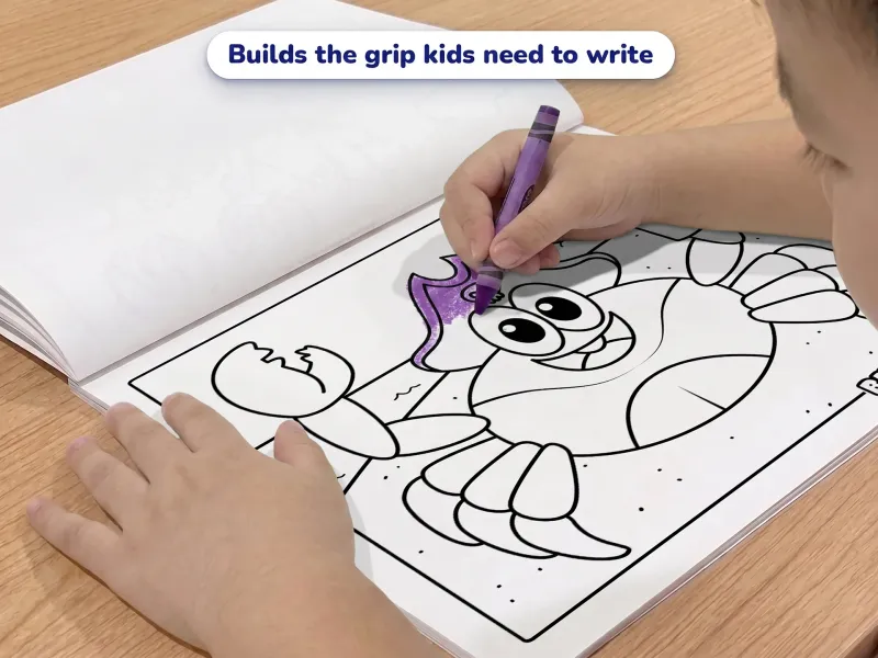 Child with a crayon coloring a picture of a pirate crab