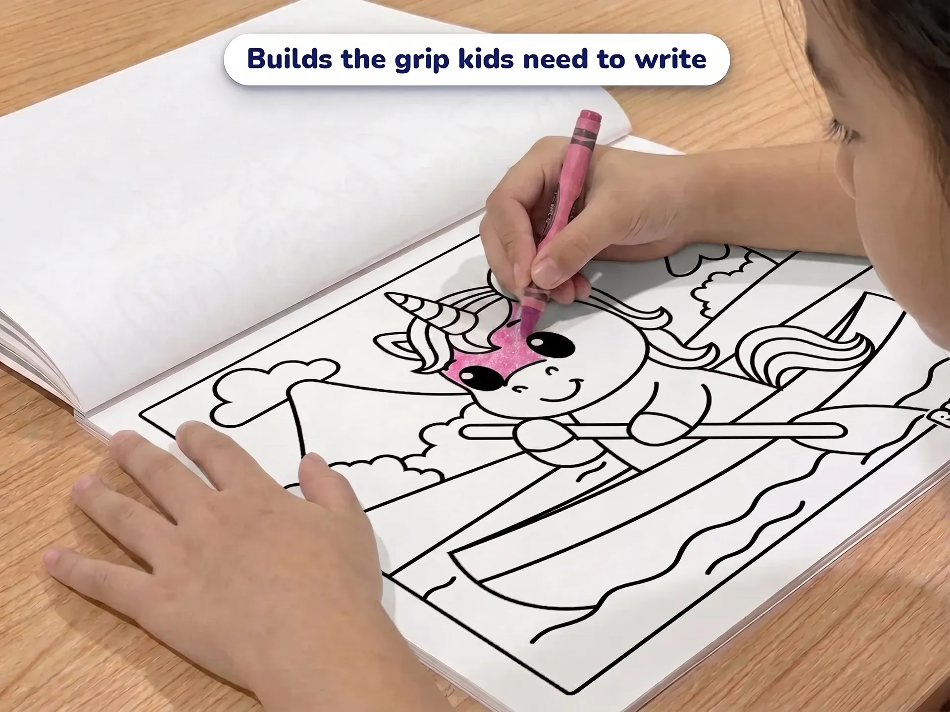 A young child coloring a picture of a unicorn in a rowing boat