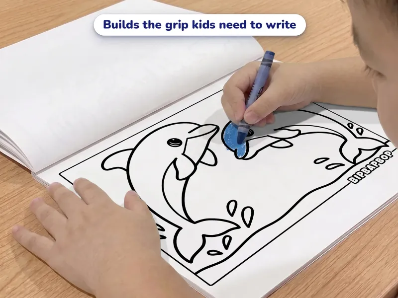 Child with a crayon coloring a picture of two dolphins jumping out of the ocean