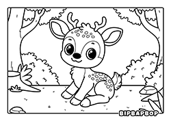 a baby deer sitting on the grass